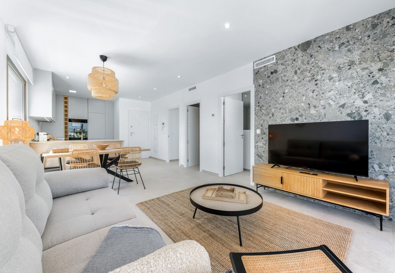 Beautiful living room with flat-screen TV and golf course views.